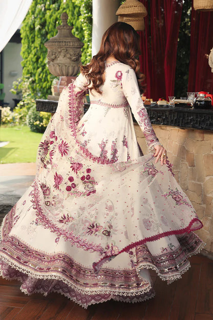 Woman in a white and purple embroidered traditional dress standing outdoors.