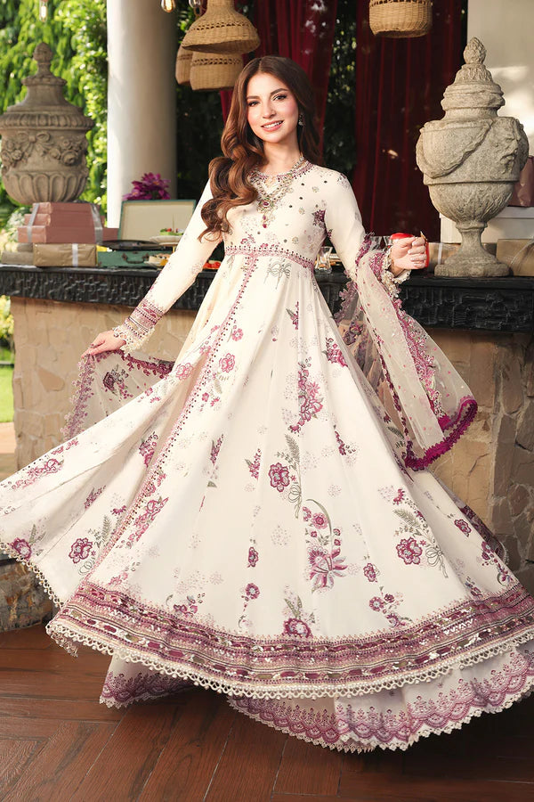 Woman in a white and pink floral traditional outfit standing outdoors.