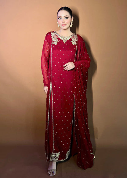  Agha Jaan deep red Pakistani designer dress with gold embroidery and sequin detail.  