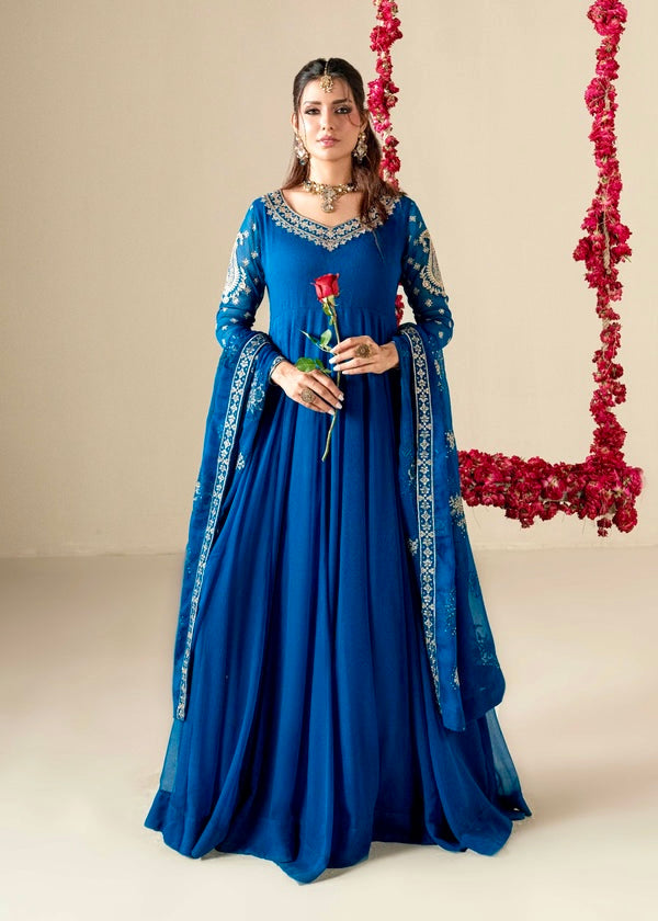 Woman in a blue traditional outfit holding a red rose against a neutral background