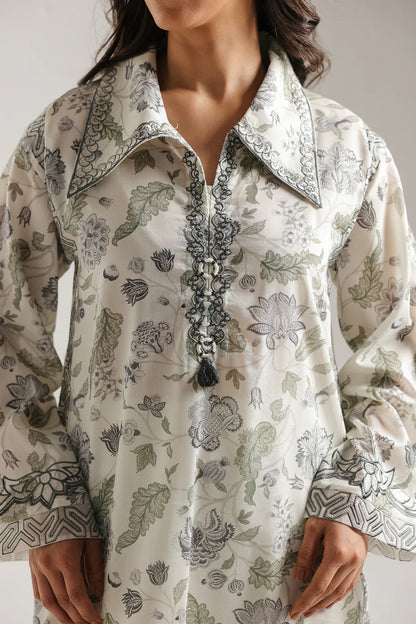 Woman wearing a floral patterned blouse with a white background