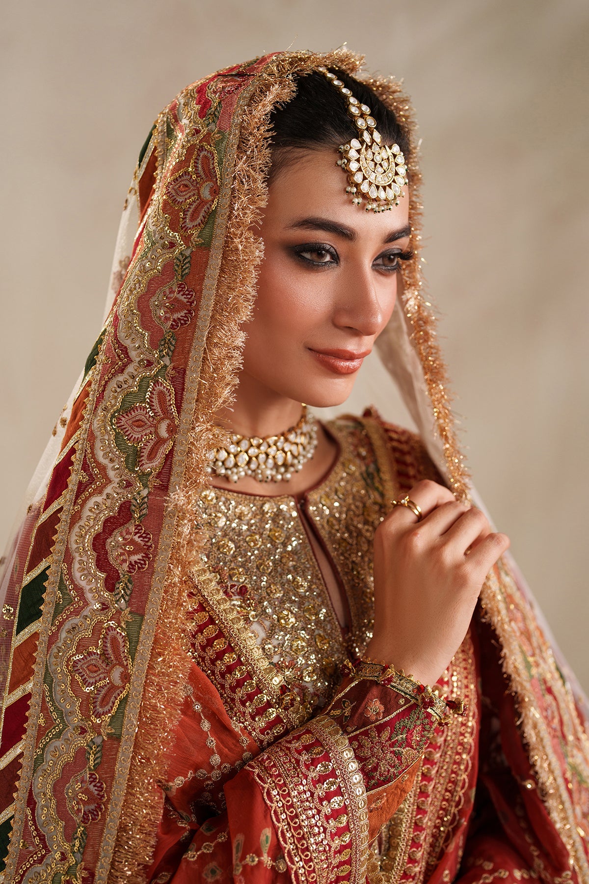 Exquisite Baroque unstitched 4-piece net suit with rich gold embellishments and floral motifs.