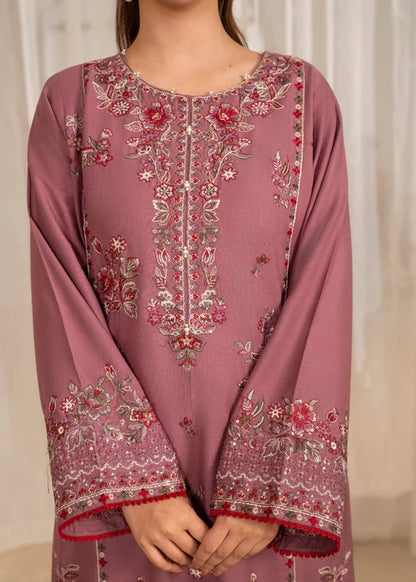 Mauve embroidered traditional outfit with floral patterns on a neutral background