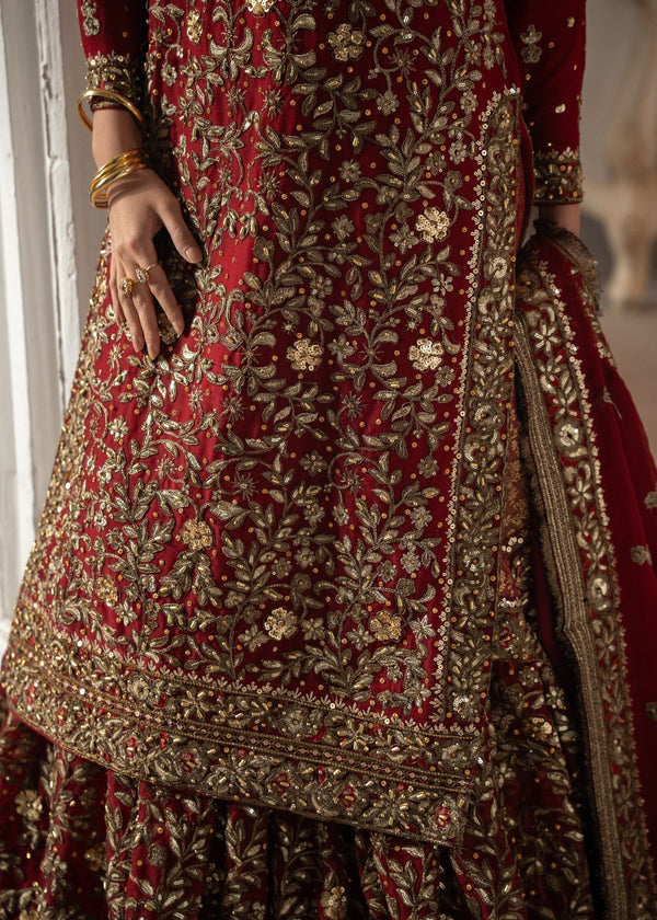 Red and gold embroidered traditional outfit with intricate patterns