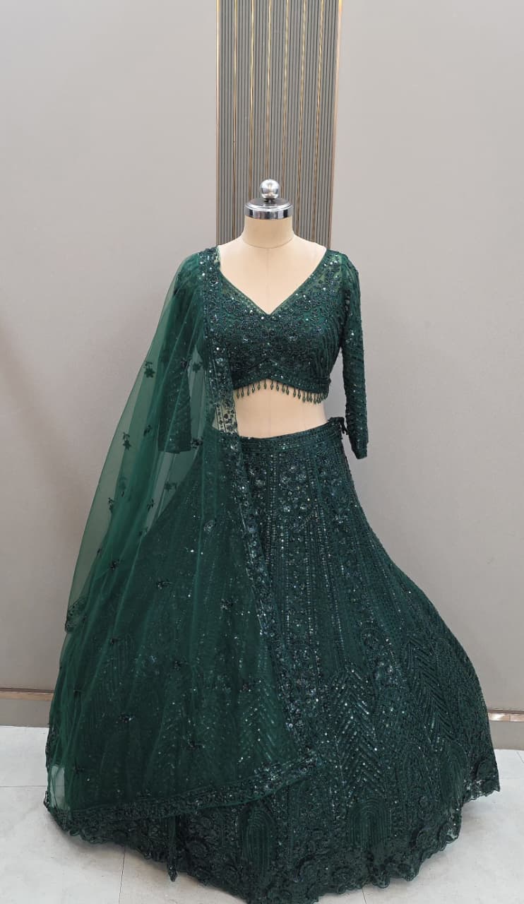 Deep emerald green heavy embroidered net lehenga for wedding and festive occasions by Tajori