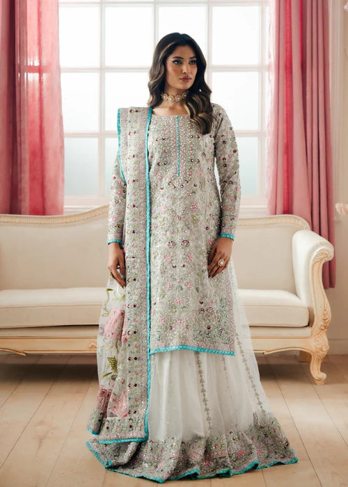 Model wearing white Zarghona floral net lehenga set, Haseens premium designer suit