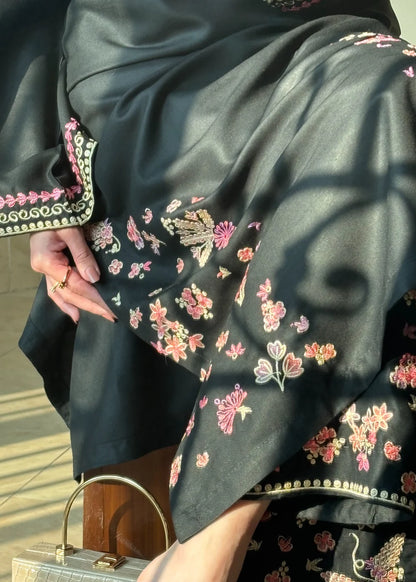 Close up of intricate floral embroidery design on black lawn dress fabric